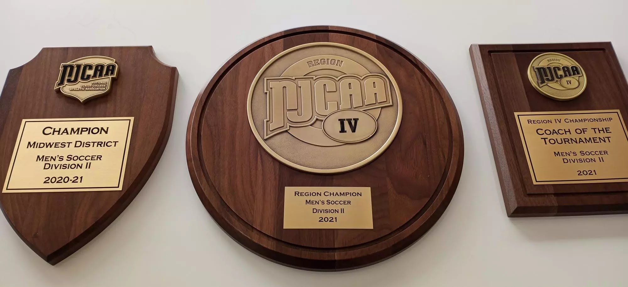 NJCAA shield, round and rectangular wood awards with gold-coloured emblems