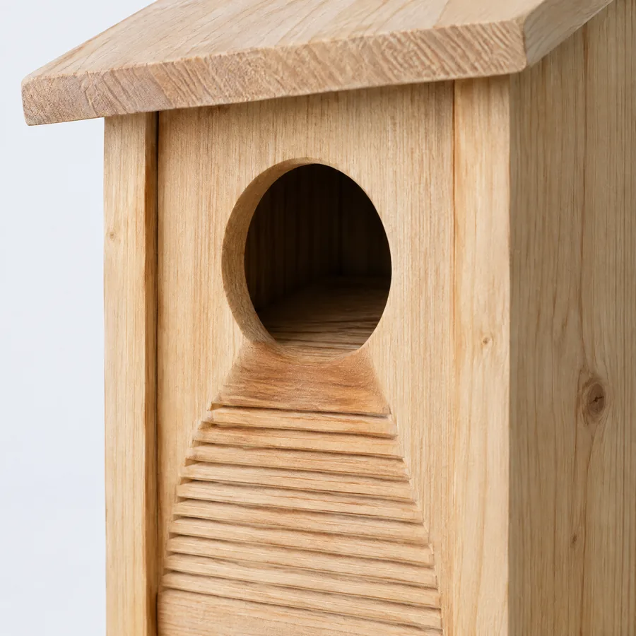 Unbranded round entrance detail on a natural wood nest box