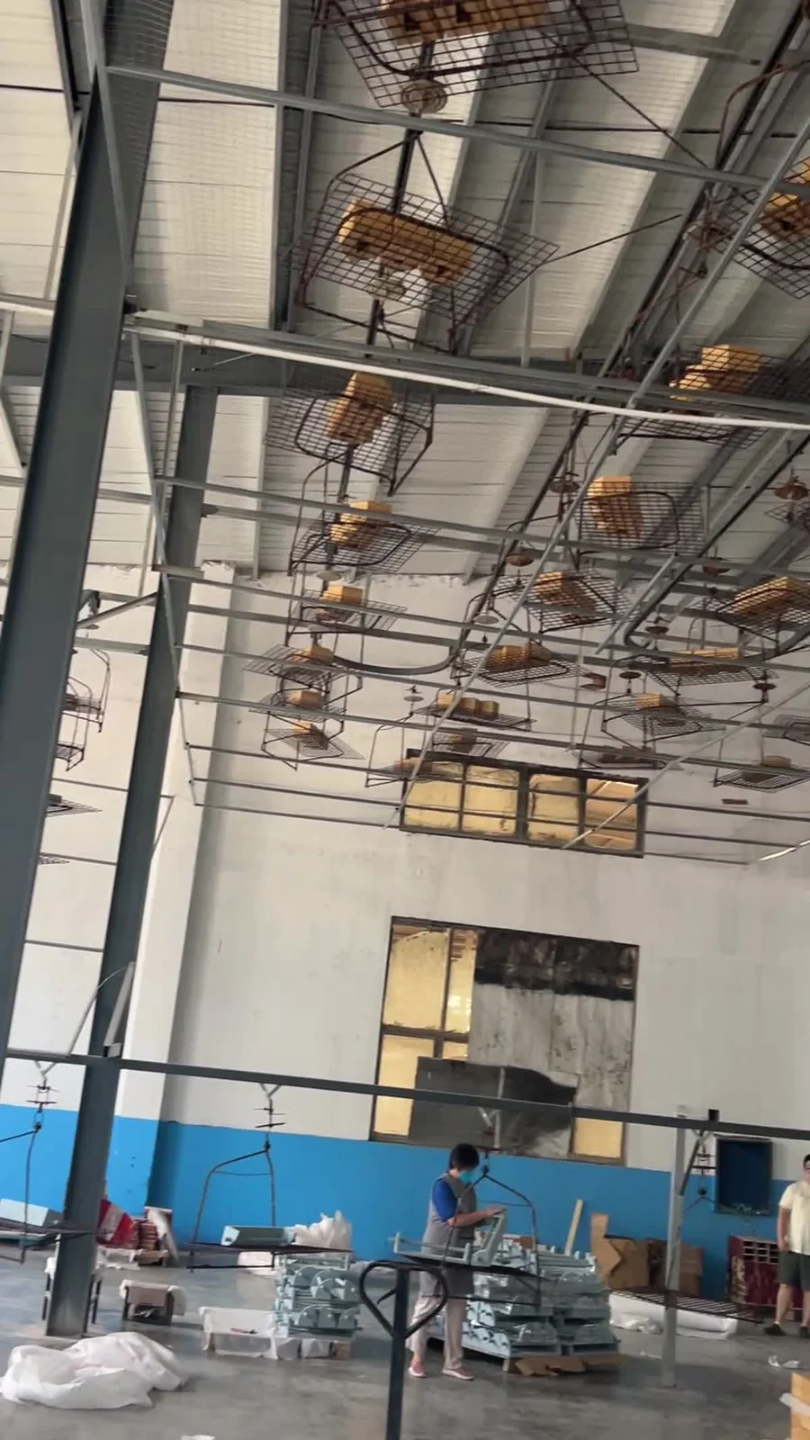 Wood components moving through the factory finishing area