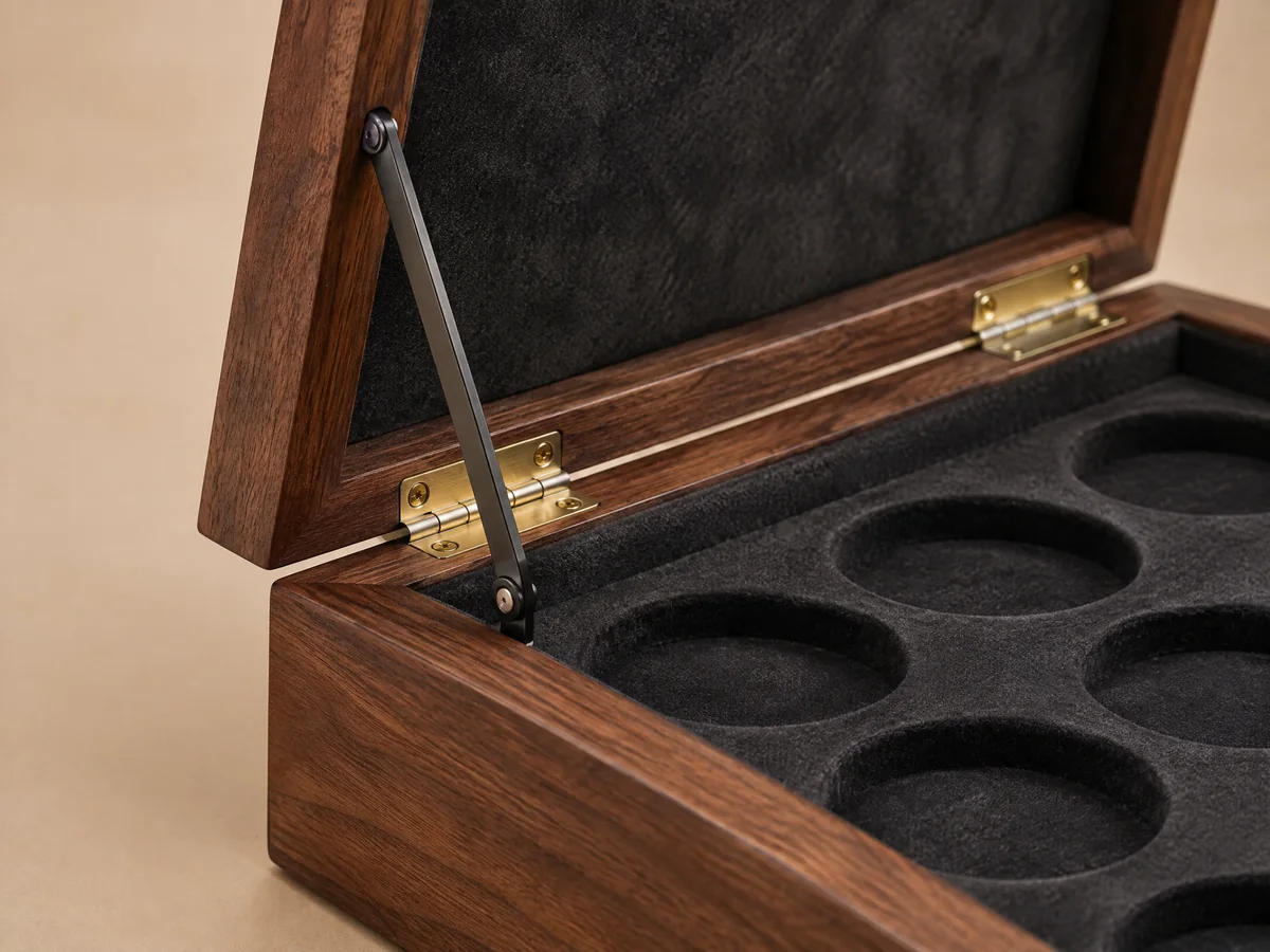 Visible brass hinge and lid stay inside a coin case