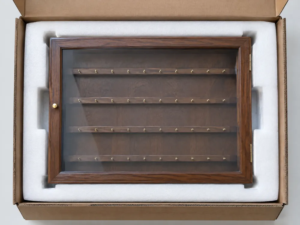 Unbranded medal display cabinet protected by fitted EPE foam inside a corrugated shipping carton