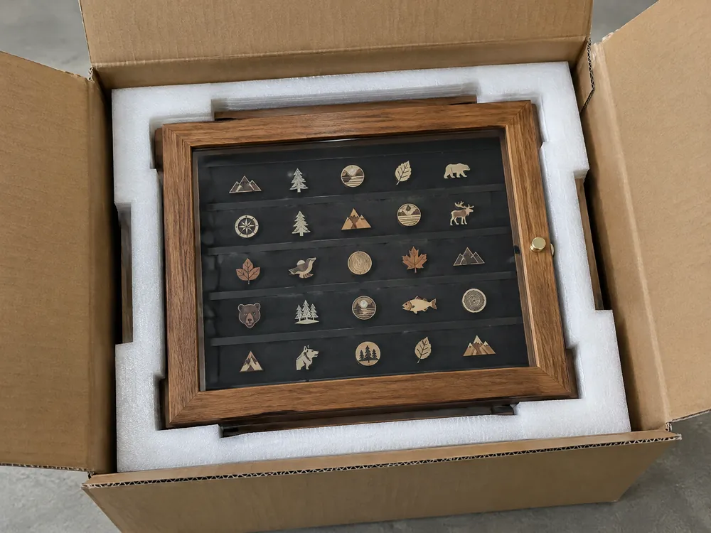 Unbranded lapel pin display case protected by fitted EPE foam in a corrugated carton