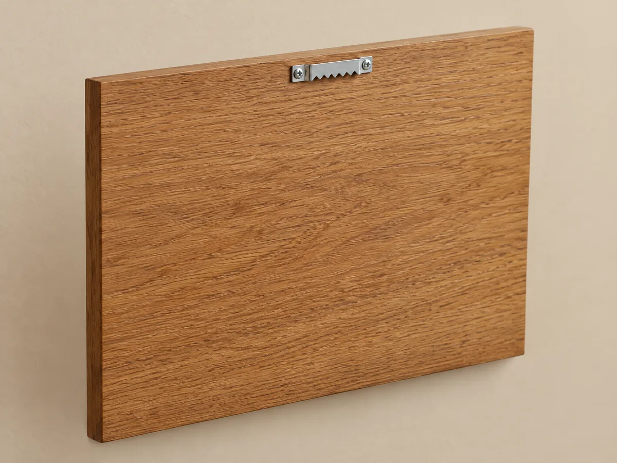 Sawtooth Hanger shown on the back of a custom wood plaque
