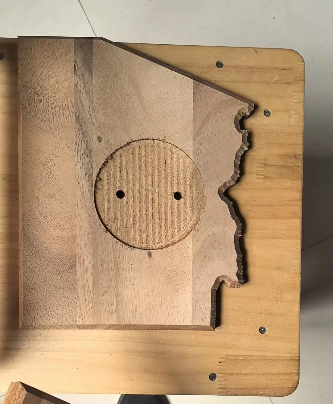 Unbranded custom wood trophy component with a cut outline, recessed circular zone, and drilled holes