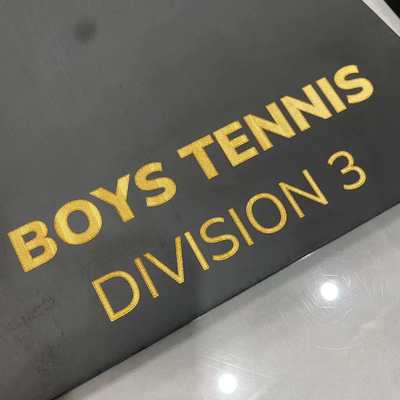 Unbranded black presentation face with gold-fill sports text